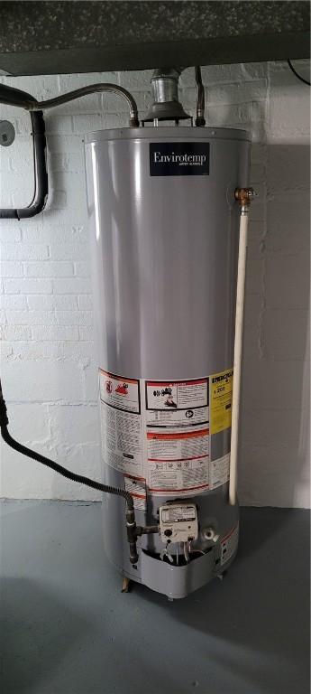 utility room featuring water heater