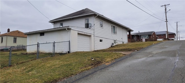 view of side of home with a garage and a yard