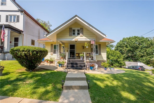 bungalow-style home featuring a porch and a front yard