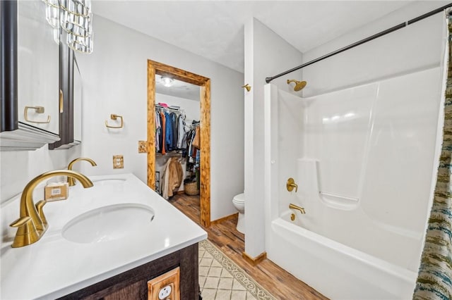 full bathroom featuring wood-type flooring, toilet, vanity, and shower / bath combo