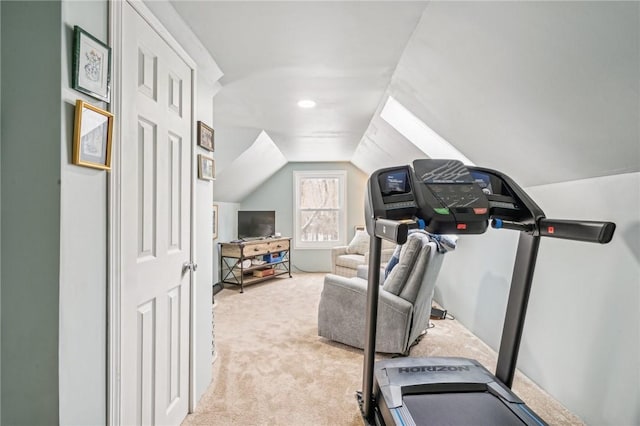 workout area featuring vaulted ceiling and light carpet