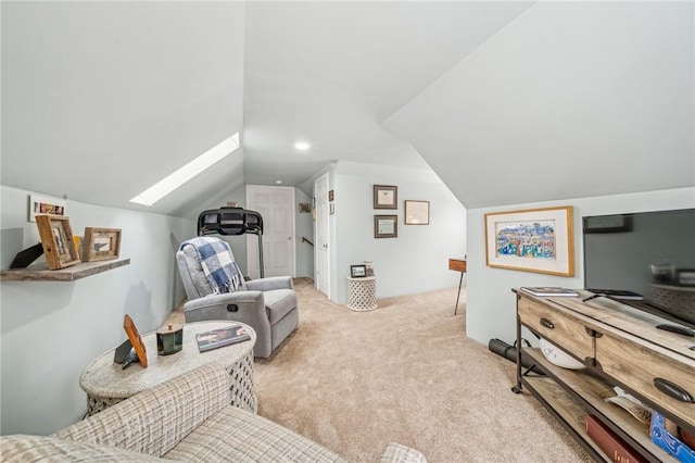 interior space with light colored carpet and vaulted ceiling with skylight