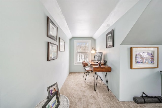 hallway with light colored carpet and vaulted ceiling