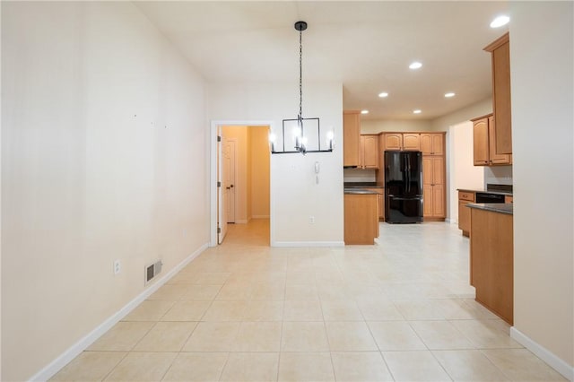 kitchen with pendant lighting, a notable chandelier, light tile patterned floors, and black appliances