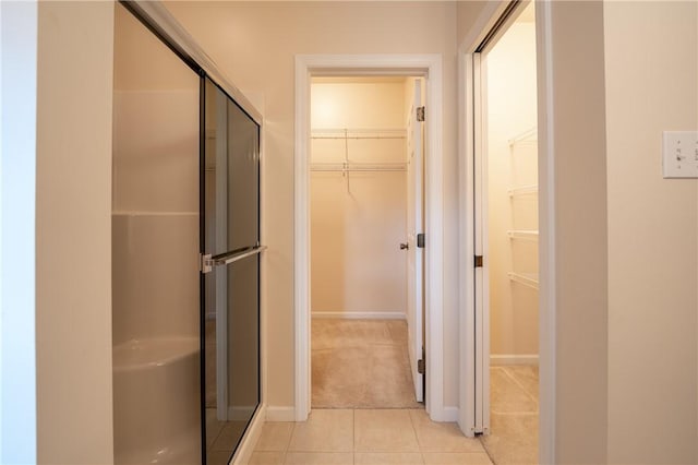 bathroom featuring a shower with door and tile patterned floors