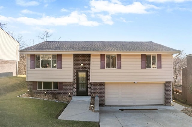 raised ranch with a garage and a front yard