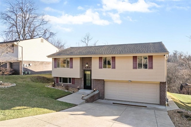 split foyer home featuring a garage and a front lawn