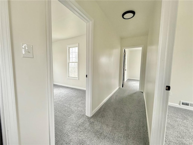 corridor featuring light colored carpet