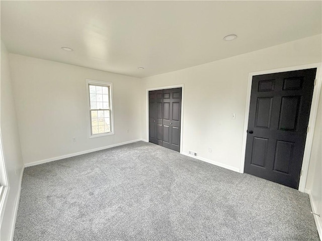 unfurnished bedroom with carpet floors and a closet