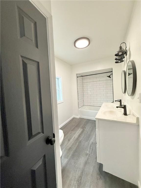 bathroom featuring hardwood / wood-style flooring, vanity, and toilet