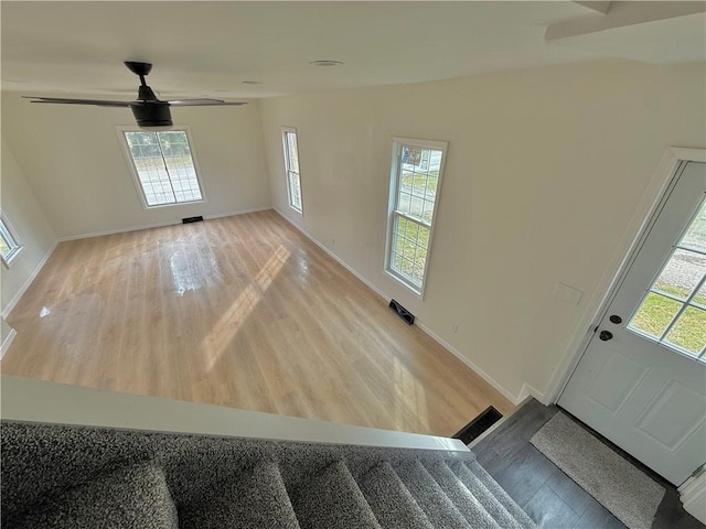 entryway featuring ceiling fan, a healthy amount of sunlight, and light wood-type flooring