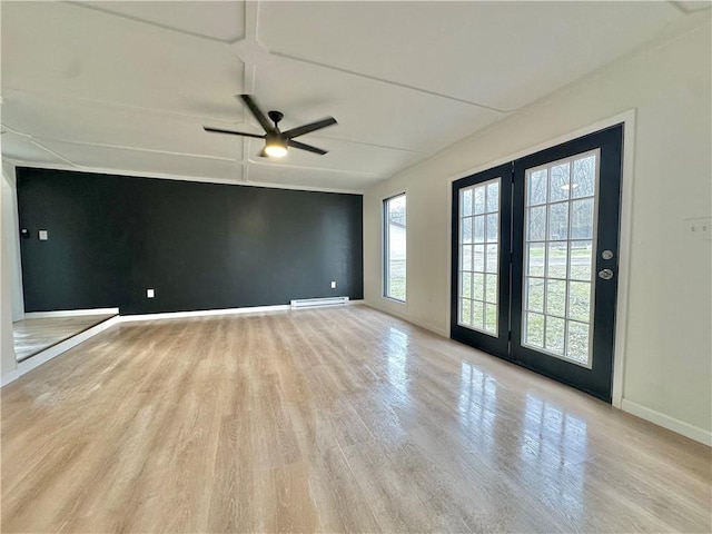 spare room featuring ceiling fan, light hardwood / wood-style floors, and a baseboard radiator