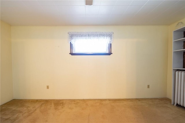 carpeted empty room with radiator