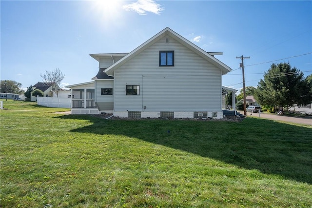 view of side of property featuring central AC unit and a lawn