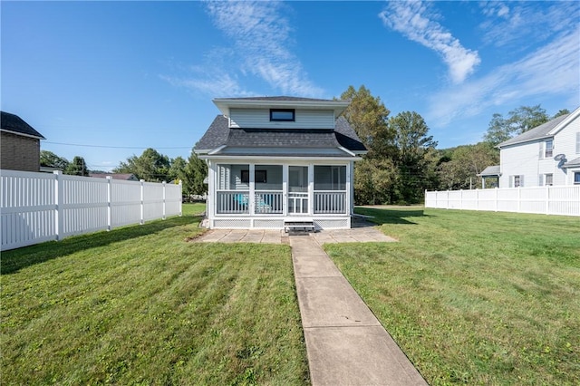 back of property with covered porch and a lawn