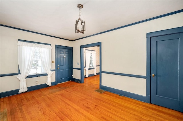 foyer with hardwood / wood-style floors and ornamental molding