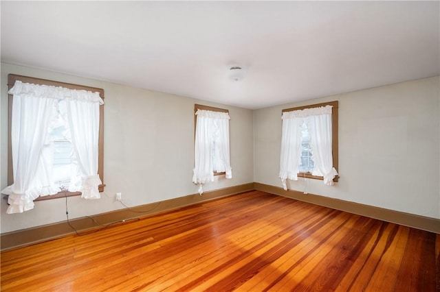 spare room with light hardwood / wood-style floors and a wealth of natural light