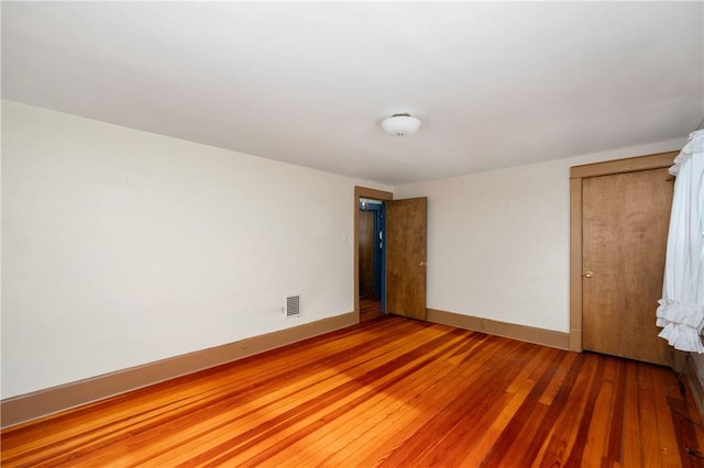 unfurnished bedroom with wood-type flooring