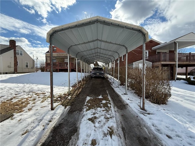 view of snow covered parking area