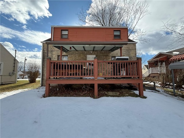 view of snow covered rear of property