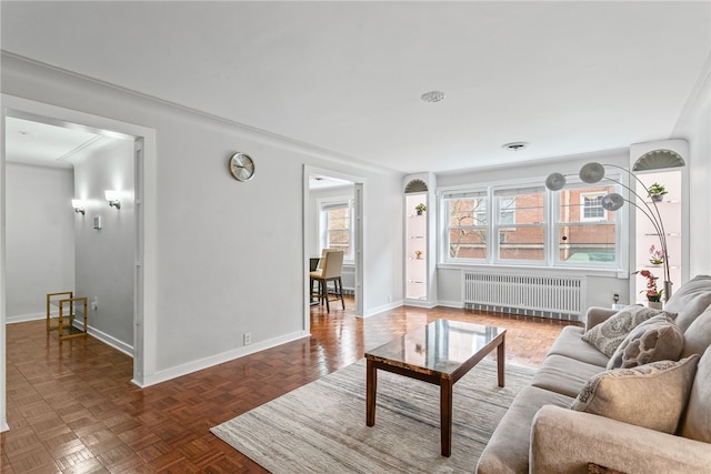 living room featuring dark parquet flooring and radiator heating unit