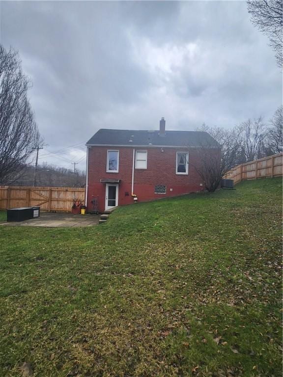 back of house featuring a patio and a lawn