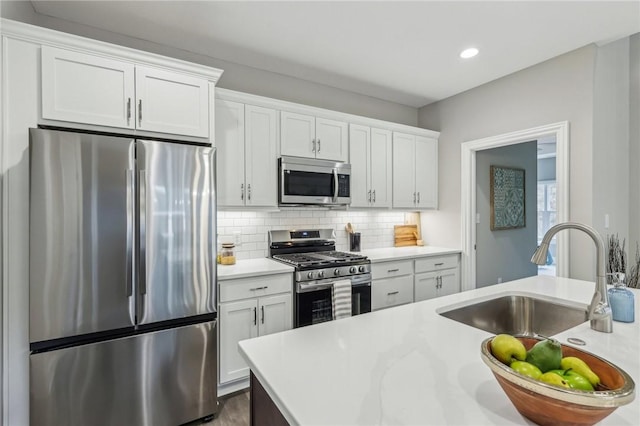 1045 Lakeside Dr, Mcdonald Wsh, PA 15057 - kitchen featuring tasteful backsplash, appliances with stainless steel finishes, sink, and white cabinets