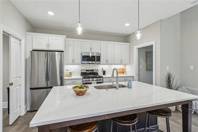 1045 Lakeside Dr, Mcdonald Wsh, PA 15057 - kitchen featuring sink, an island with sink, white cabinets, and appliances with stainless steel finishes