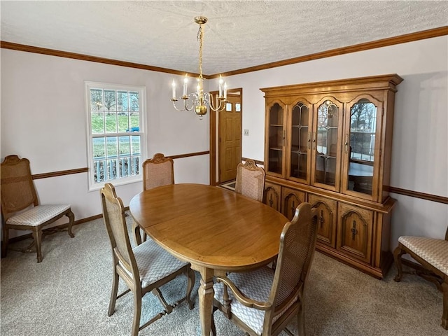 carpeted dining space featuring crown molding, a textured ceiling, and a notable chandelier