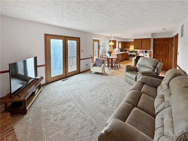 living room with light carpet and a textured ceiling