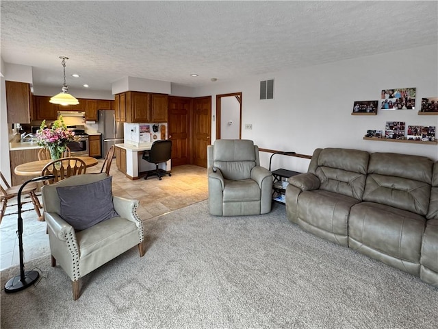 living room with light carpet and a textured ceiling