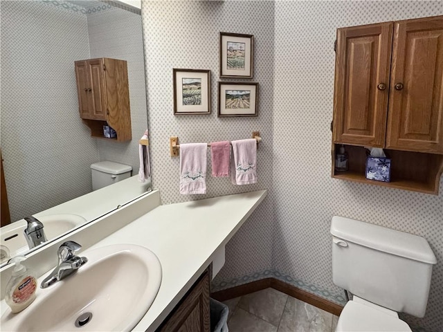 bathroom with tile patterned flooring, vanity, and toilet