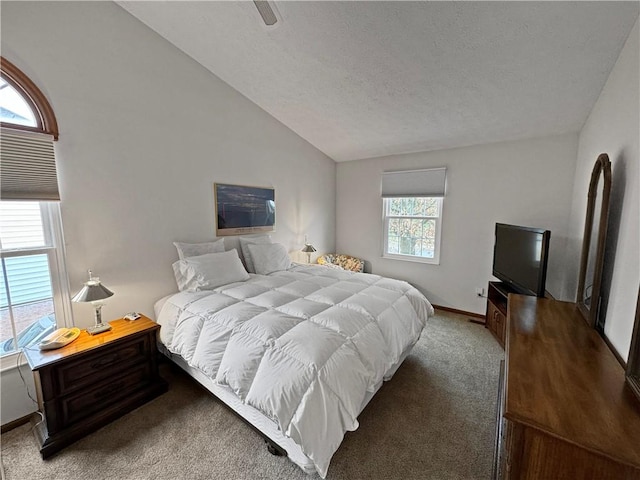 carpeted bedroom featuring lofted ceiling, a textured ceiling, and ceiling fan