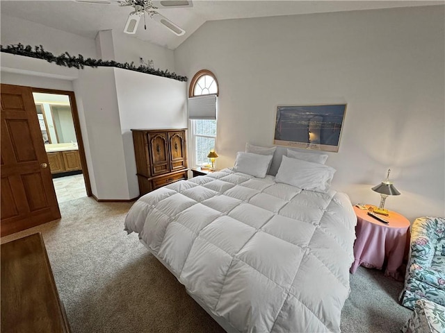 bedroom featuring connected bathroom, vaulted ceiling, light colored carpet, and ceiling fan