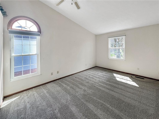 carpeted spare room with baseboards, a ceiling fan, and lofted ceiling
