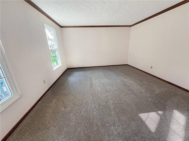 empty room with crown molding, baseboards, and carpet floors