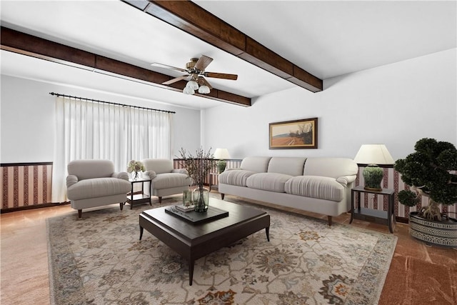 living room featuring beamed ceiling, carpet, and ceiling fan