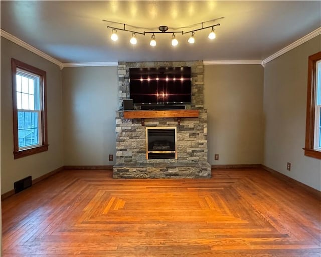 unfurnished living room with ornamental molding and parquet floors