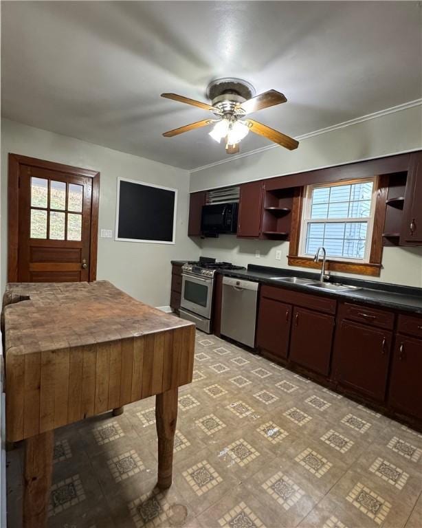 kitchen with dark brown cabinetry, appliances with stainless steel finishes, sink, and plenty of natural light