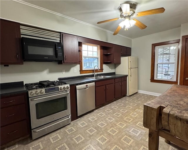 kitchen featuring stainless steel appliances, ceiling fan, sink, and dark brown cabinetry