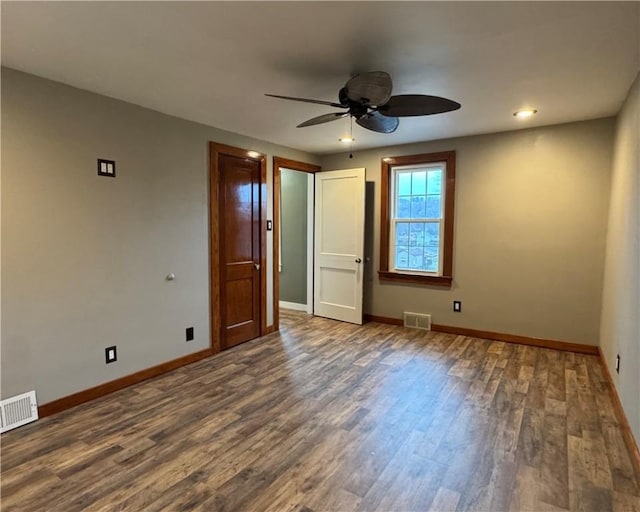 unfurnished bedroom with dark hardwood / wood-style floors and ceiling fan