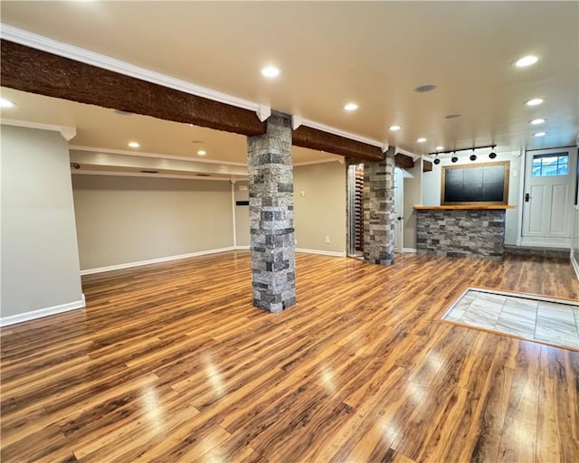 unfurnished living room with crown molding and hardwood / wood-style floors