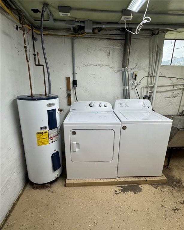 clothes washing area featuring washing machine and dryer and electric water heater