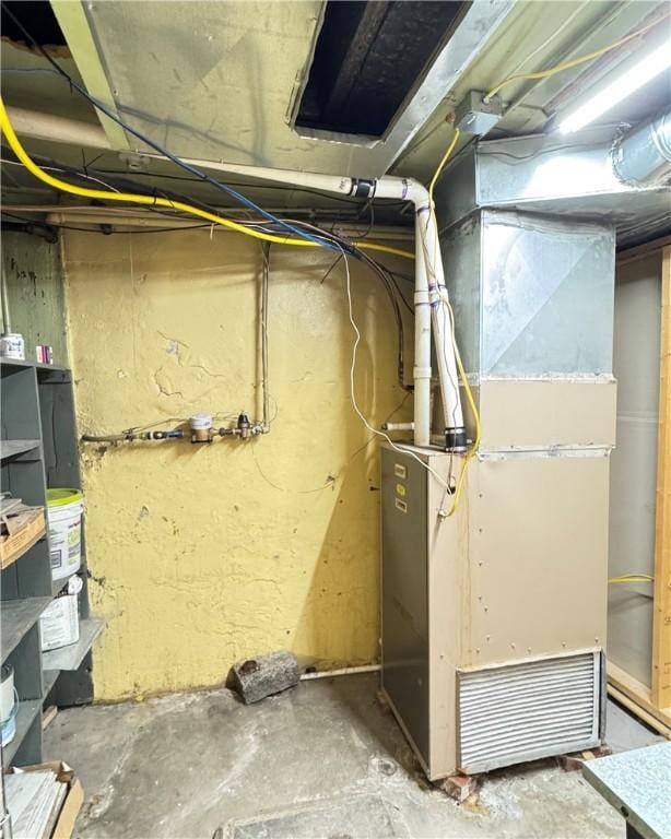 utility room featuring heating unit