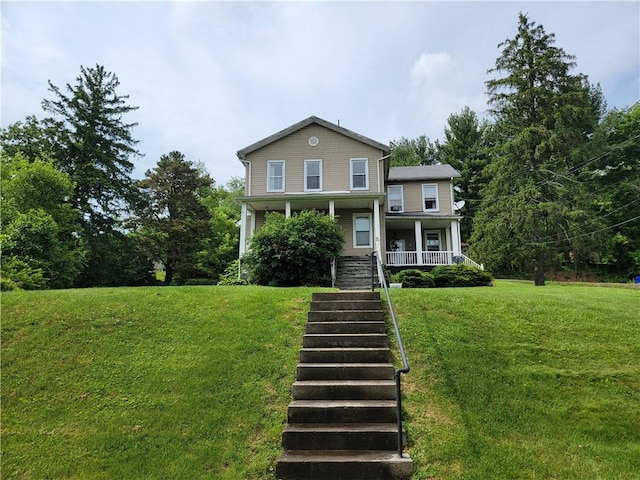 view of front of property featuring a front lawn and covered porch