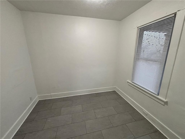 empty room with a textured ceiling