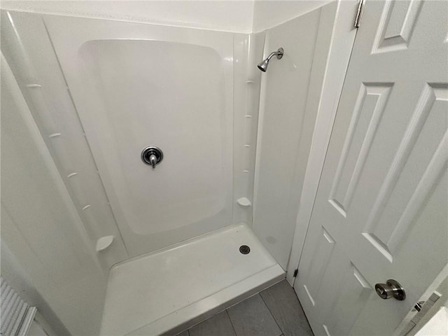 bathroom featuring tile patterned flooring and a shower