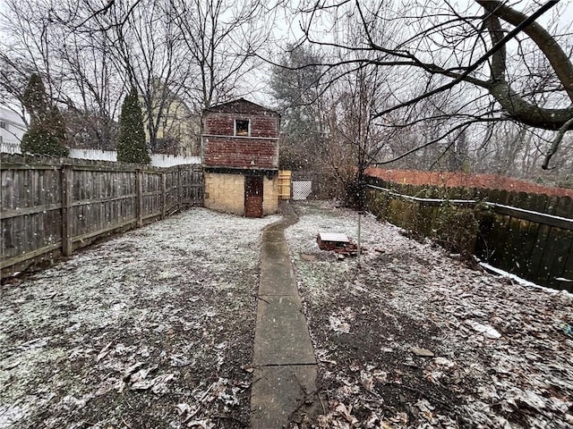 yard layered in snow with a storage unit