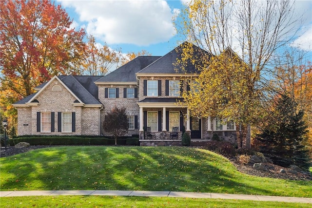 view of front of property with a porch and a front lawn