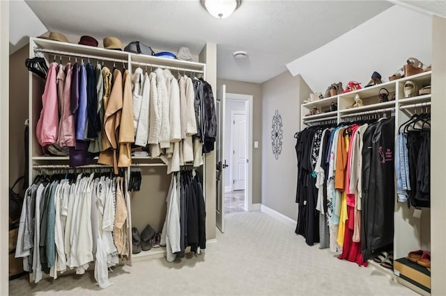 spacious closet with carpet floors